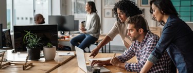 Three people looking at a laptop screen