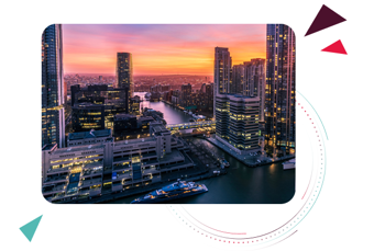 City skyline at sunset with modern high‑rise buildings overlooking a river, representing local relevance and regional HR software considerations.