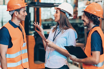 People in hardhats and hi-vis talking
