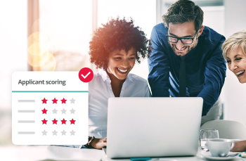 HR team reviewing applicant scoring on laptop, showcasing talent acquisition and candidate screening software