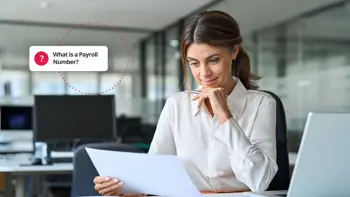 Woman looking at a report with a text box saying "What is a Payroll Number?"