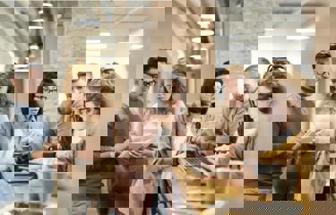 Team discussing plans during coffee