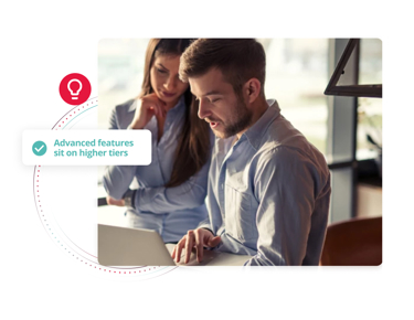 Two colleagues working together at a laptop with an overlay highlighting that advanced HR features