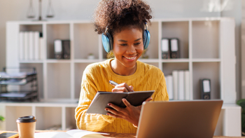 Woman taking notes on Adaptability as a KPI  from a laptop screen