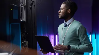 Man holding laptop working on AI for Payroll