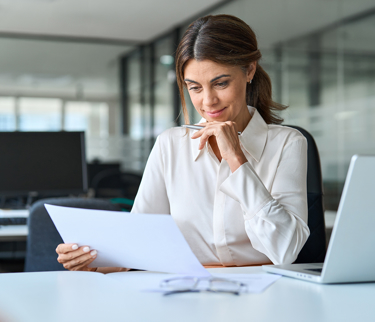 Employee working on laptop integration payroll software with a workplace pension scheme 
