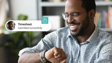 Man looking at time with text saying @Timesheet  submitted successfully"