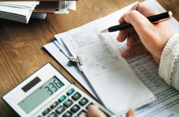Employee calculating HR system cost