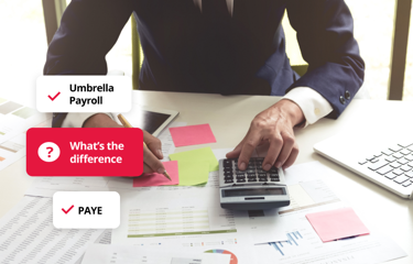 Person working at a desk with documents and calculator, illustrating the difference between umbrella payroll and PAYE.