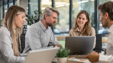 Team working on laptops managing Tupe transfers