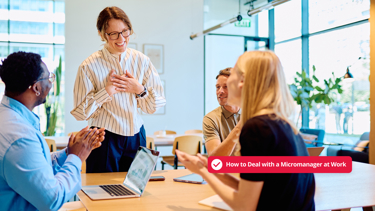 Team applauding manager during office meeting, illustrating how to deal with micromanagement at work
