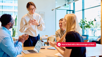 Team applauding manager during office meeting, illustrating how to deal with micromanagement at work