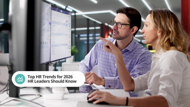Two employees looking at a desktop screen with the caption: Top HR Trends For 2026 HR Leaders Should Know